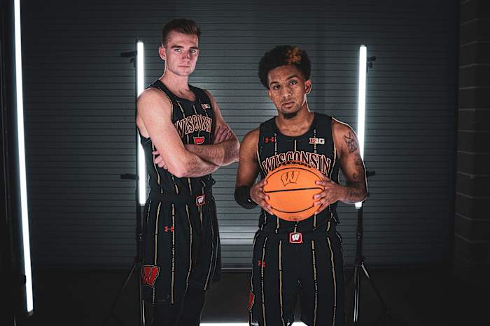 Wisconsin basketball players standing in their alternate uniforms.